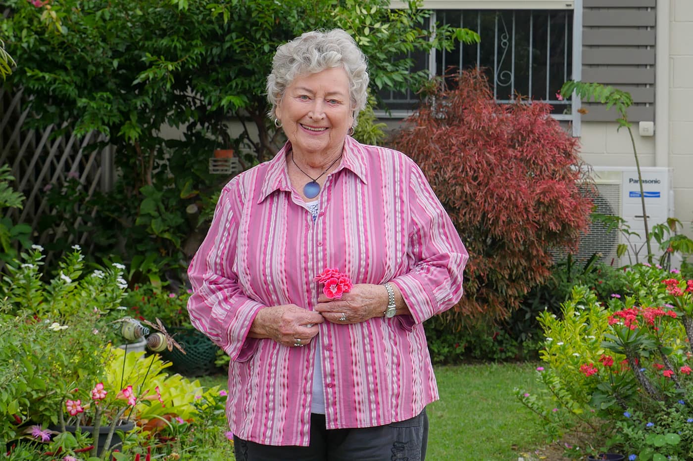 Home care recipient Patsy smiles in her garden