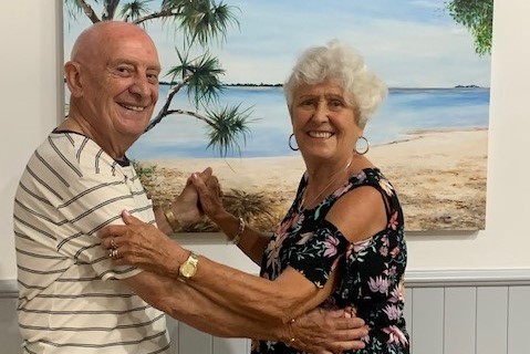 older couple dancing smiling