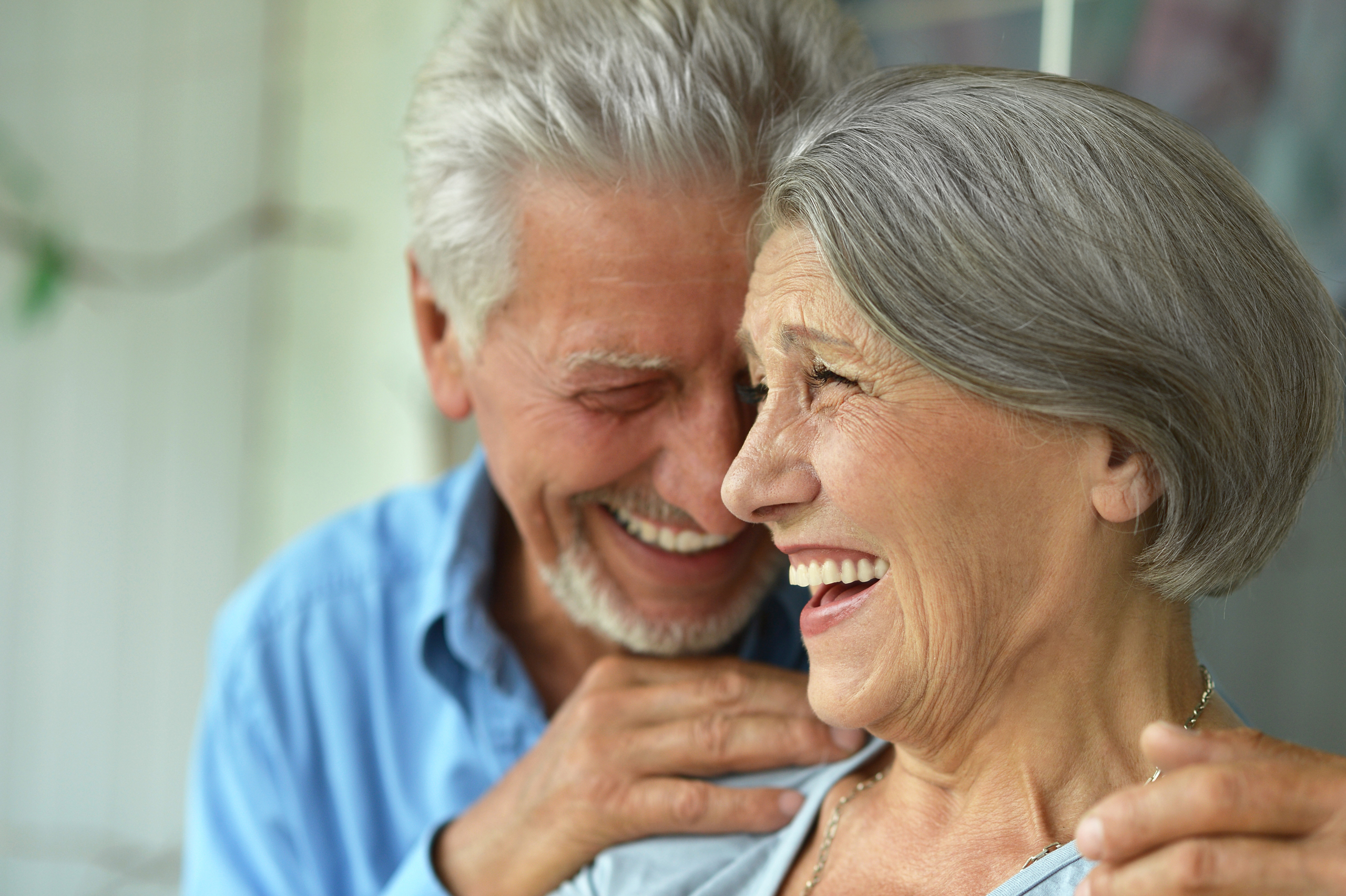 Older male and female couple smiling